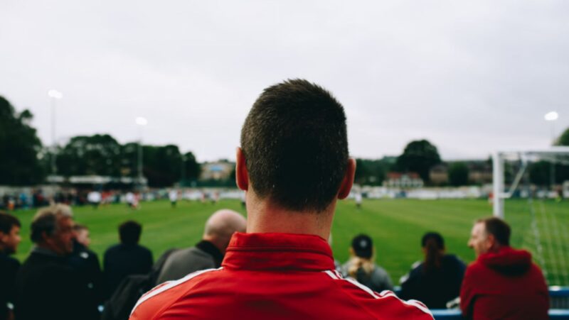 Man standing while watching soccer