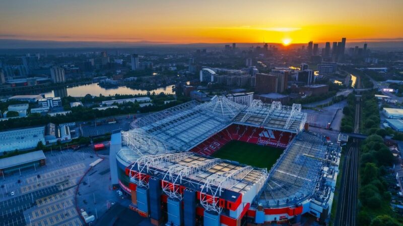 bruno fernandes record chase, kevin de bruyne stats, thierry henry goal record, premier league top scorers, soccer player records, manchester united midfielders, premier league attacking records, soccer stadium sunset, football record-breaking moments, midfielder goal achievements