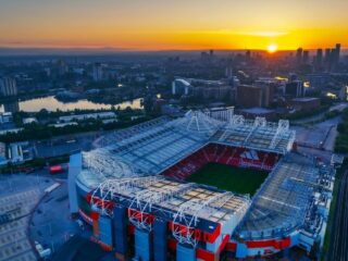bruno fernandes record chase, kevin de bruyne stats, thierry henry scoring record, premier league goal record, soccer midfield legends, manchester united players, soccer goal records, football scoring achievements, best midfielders premier league, soccer stadium sunset